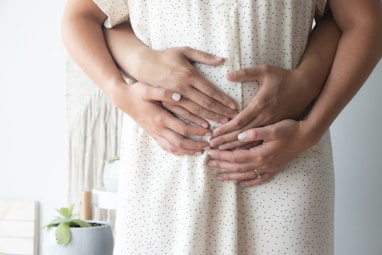 Couple holding pregnant belly