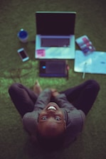 top view photo of woman sitting near MacBook Pro facing the camera