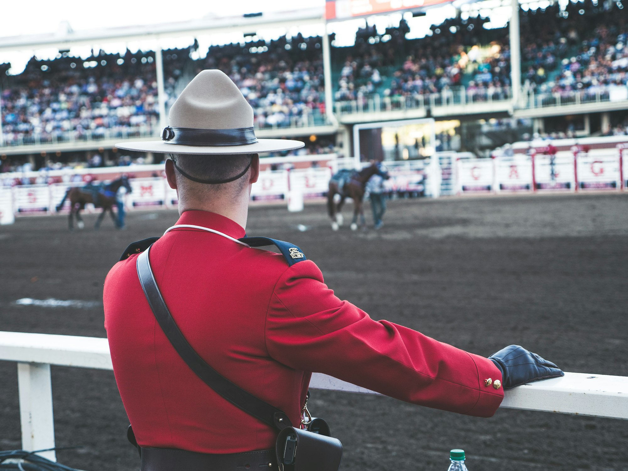The Calgary Stampede is a great tradition in Calgary. People from all over the world travel to our city to take in the specticle full of western themed entertainment, music, carnival rides, games, food and fun. This moment of an RCMP officer in the traditional Mountie uniform, watching the horses at the chuckwagon races is a moment of calm after he accompanied our nations flag on stage for our national anthem, O’Canada.