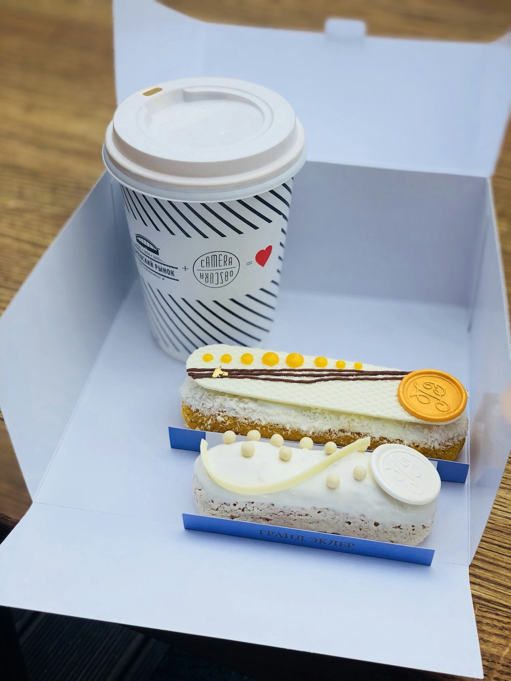 white disposable cup near cakes