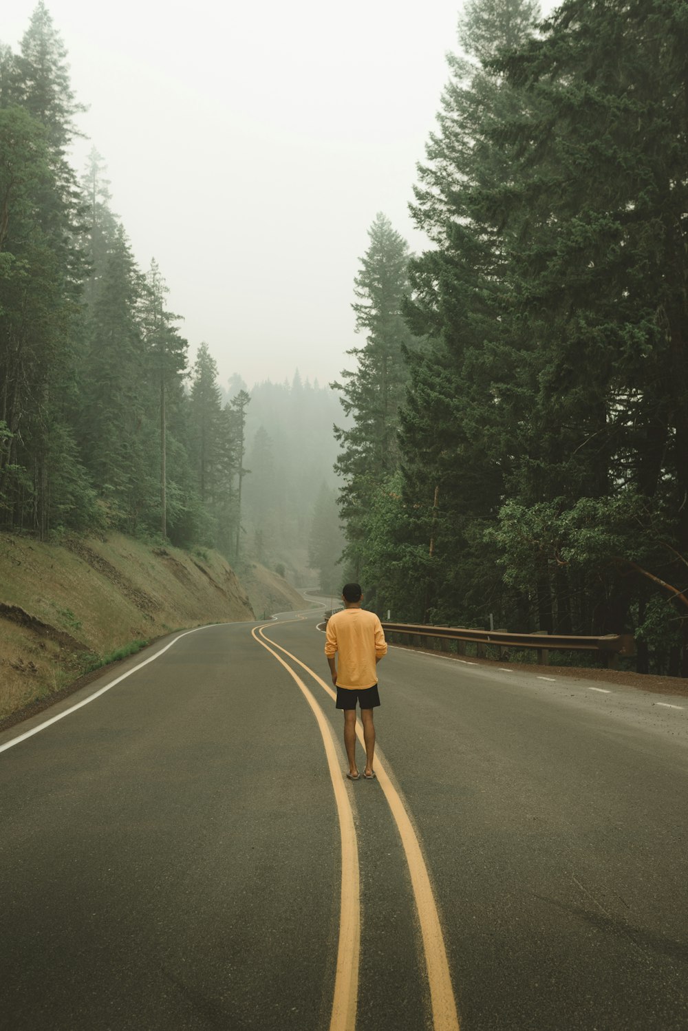 man standing at the center of the road