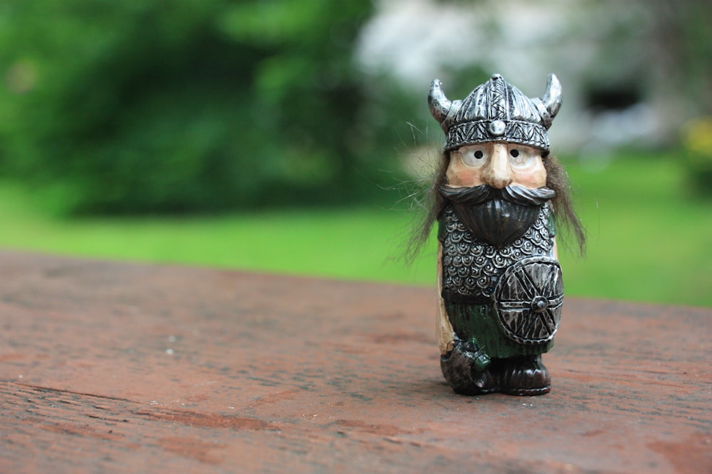 knight figurine on top of brown wood surface