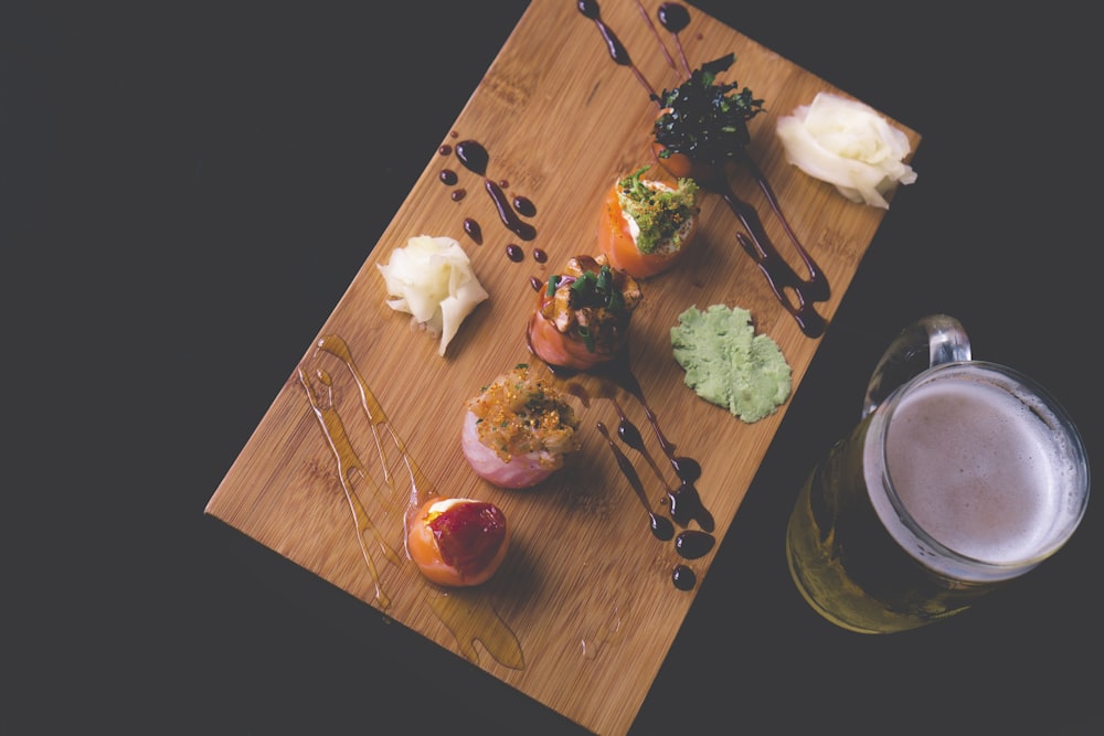 clear glass beer mug on wooden board