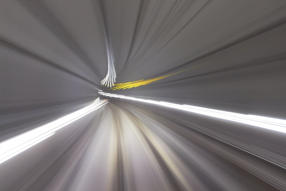 a blurry photo of a train going through a tunnel