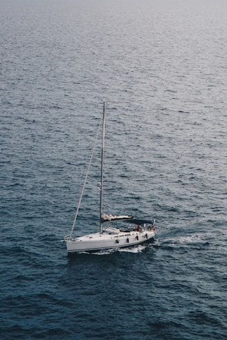 white sailboat on ocean