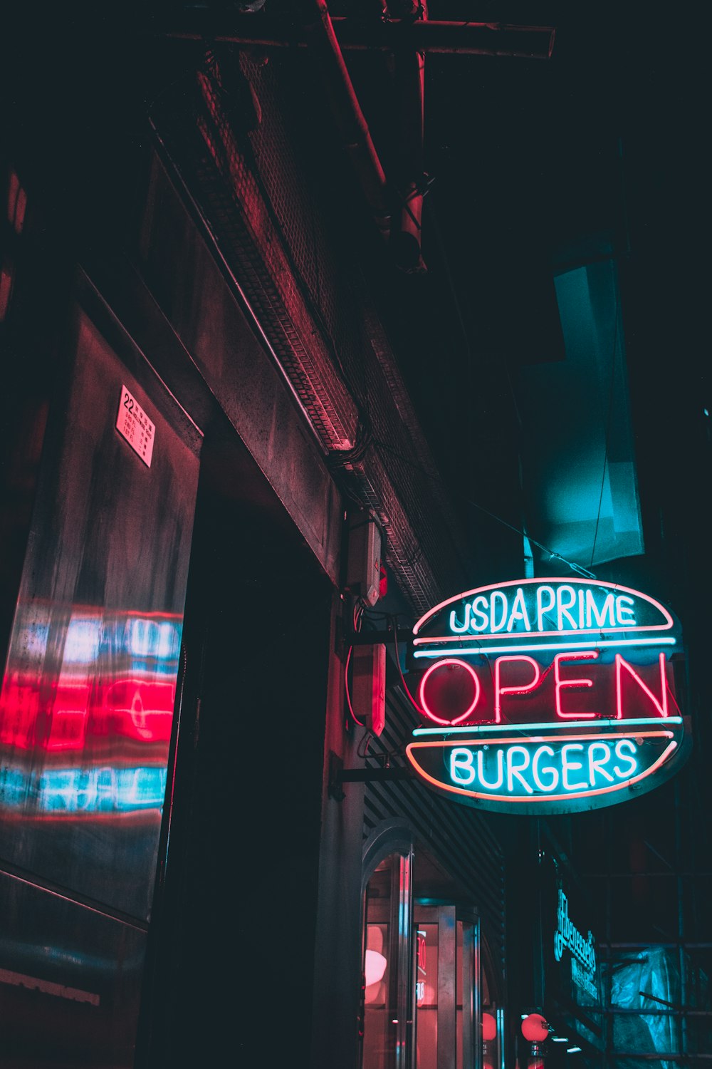 turned on blue and white Usda Prime Burgers Open neon sign