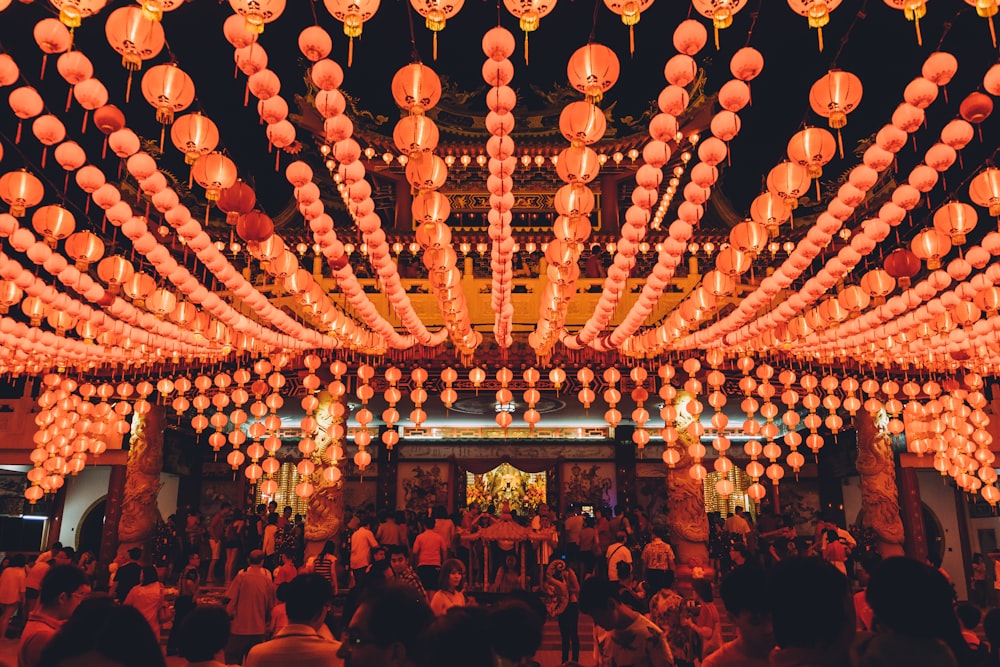 people gathering under orange paper lanterns