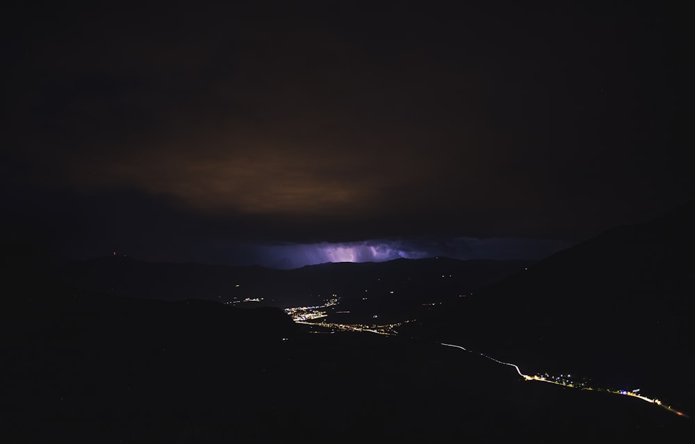 a dark sky with a lightning bolt in the distance