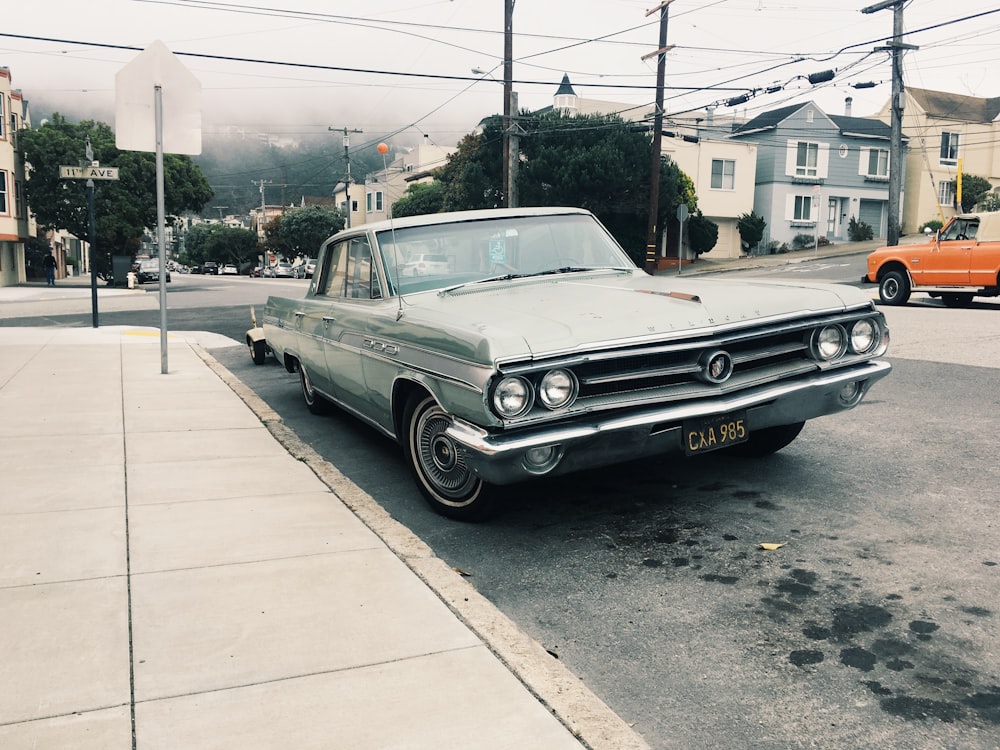 silver sedan parked near road side