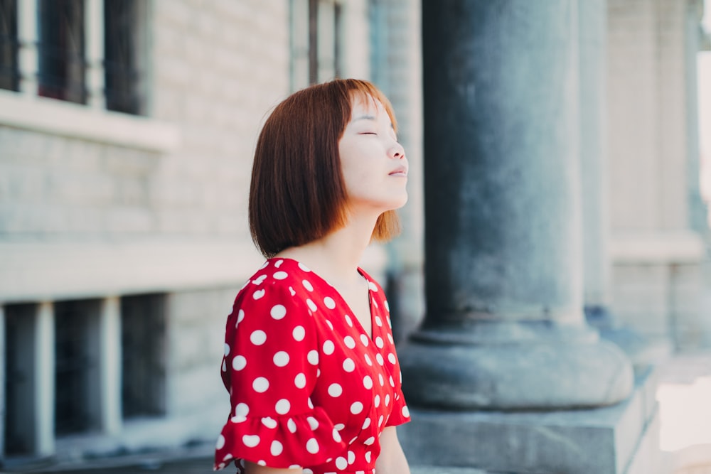 woman closed-eye sitting outdoor during daytime