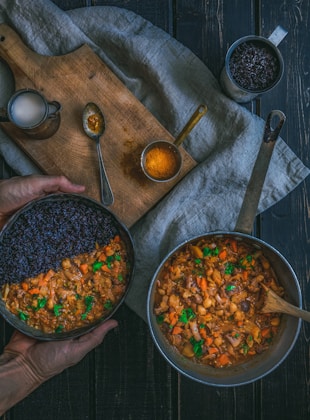 person holding pot with cook food