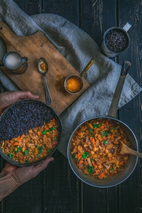person holding pot with cook food