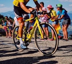 man riding yellow bicycle