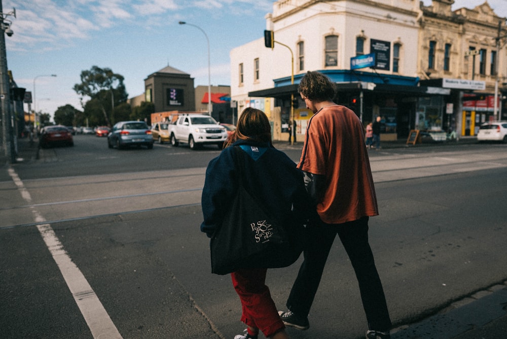 man and woman crossing the street