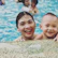 Smiling parents and children enjoying a poolside vacation together.