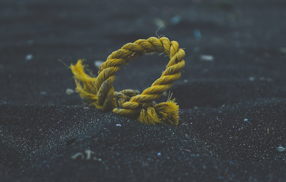 yellow rope on black sand