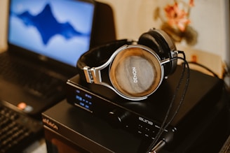 brown corded headphones on black electric device
