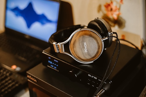 brown corded headphones on black electric device