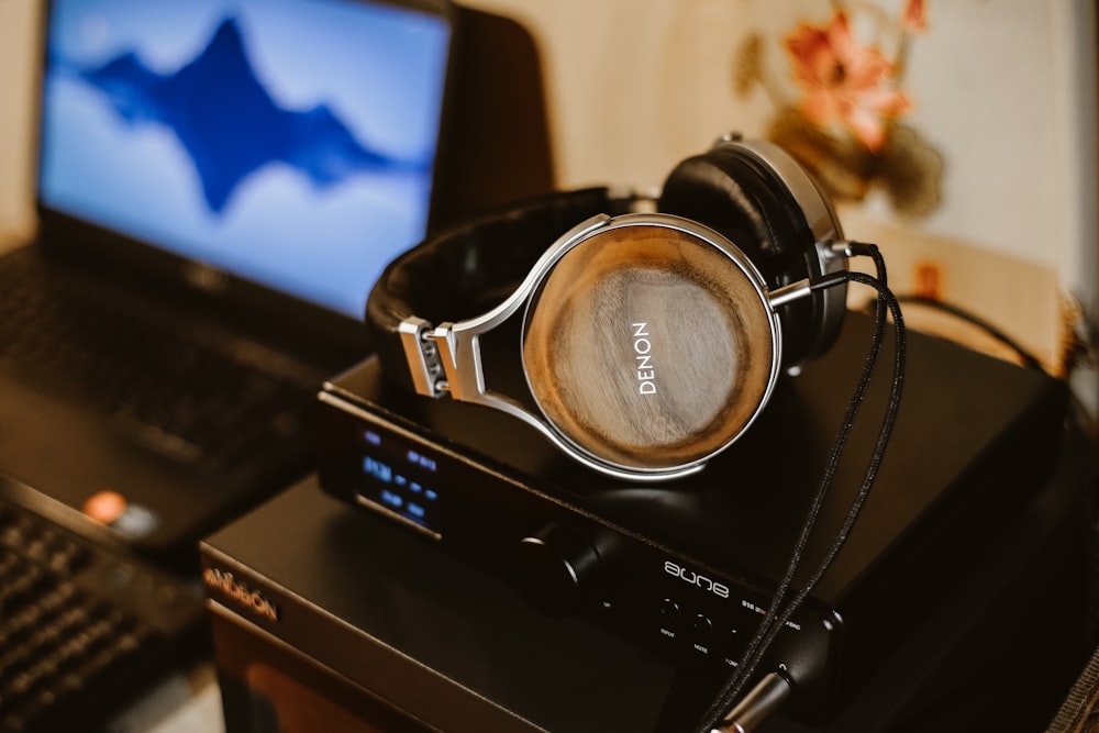 brown corded headphones on black electric device