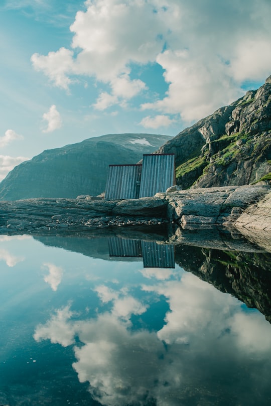 landscaped photo of a body of water and cliff in Olden Norway