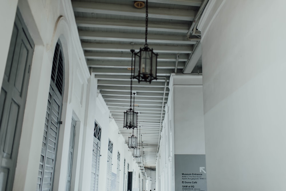 black pendant lamps on middle of hallway