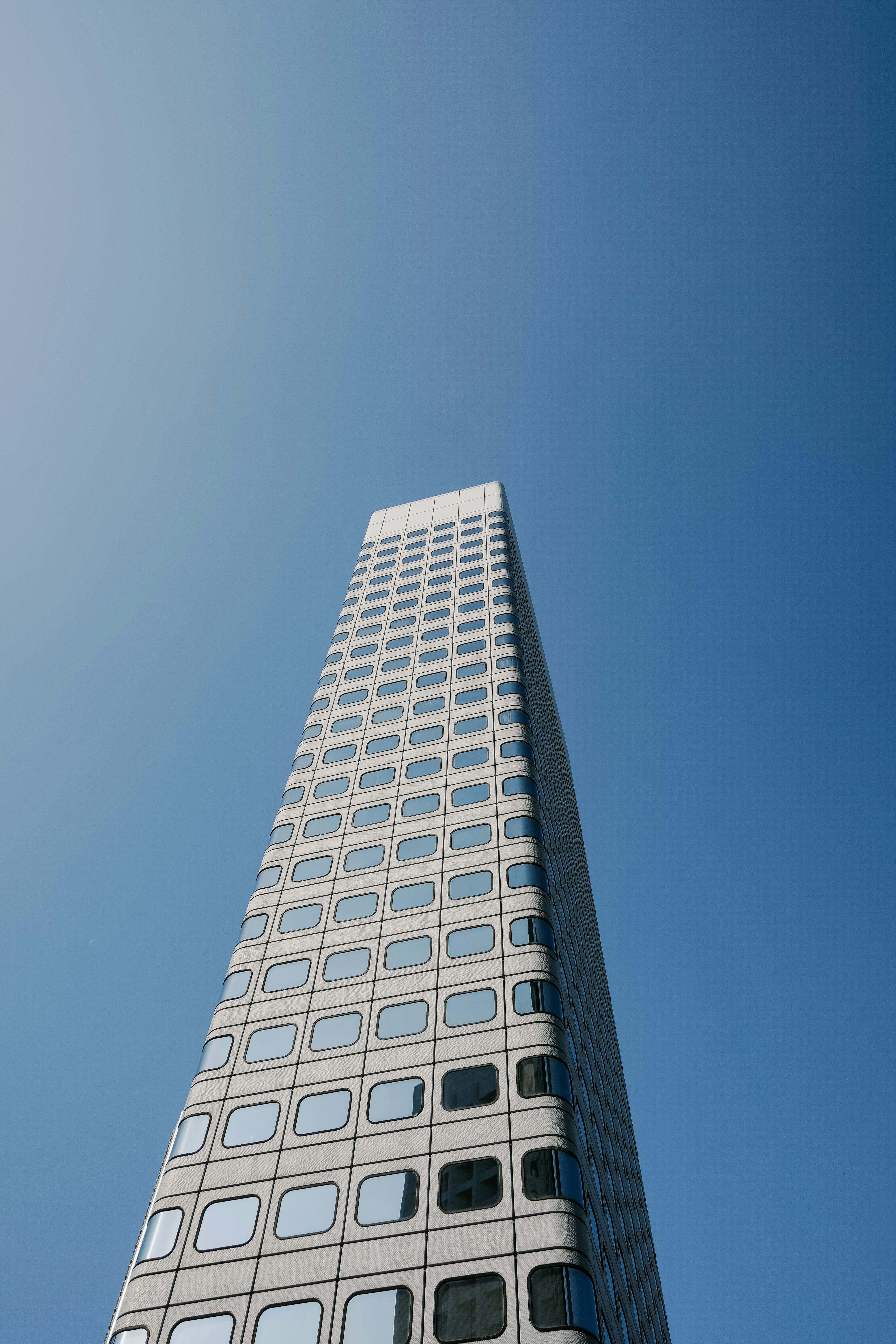 low-angle photography of grey and black high-rise building