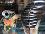 Close-up of a vintage car part with aged patina, spotlighted in deep british racing green hues.