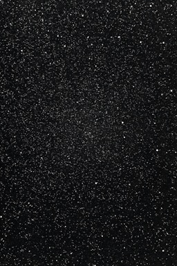 A vast expanse of space filled with countless small, bright stars scattered across a dark, seemingly infinite background.