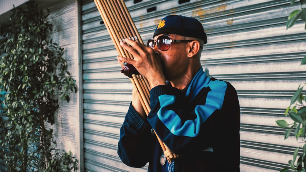 man playing wood wind instrument outdoors