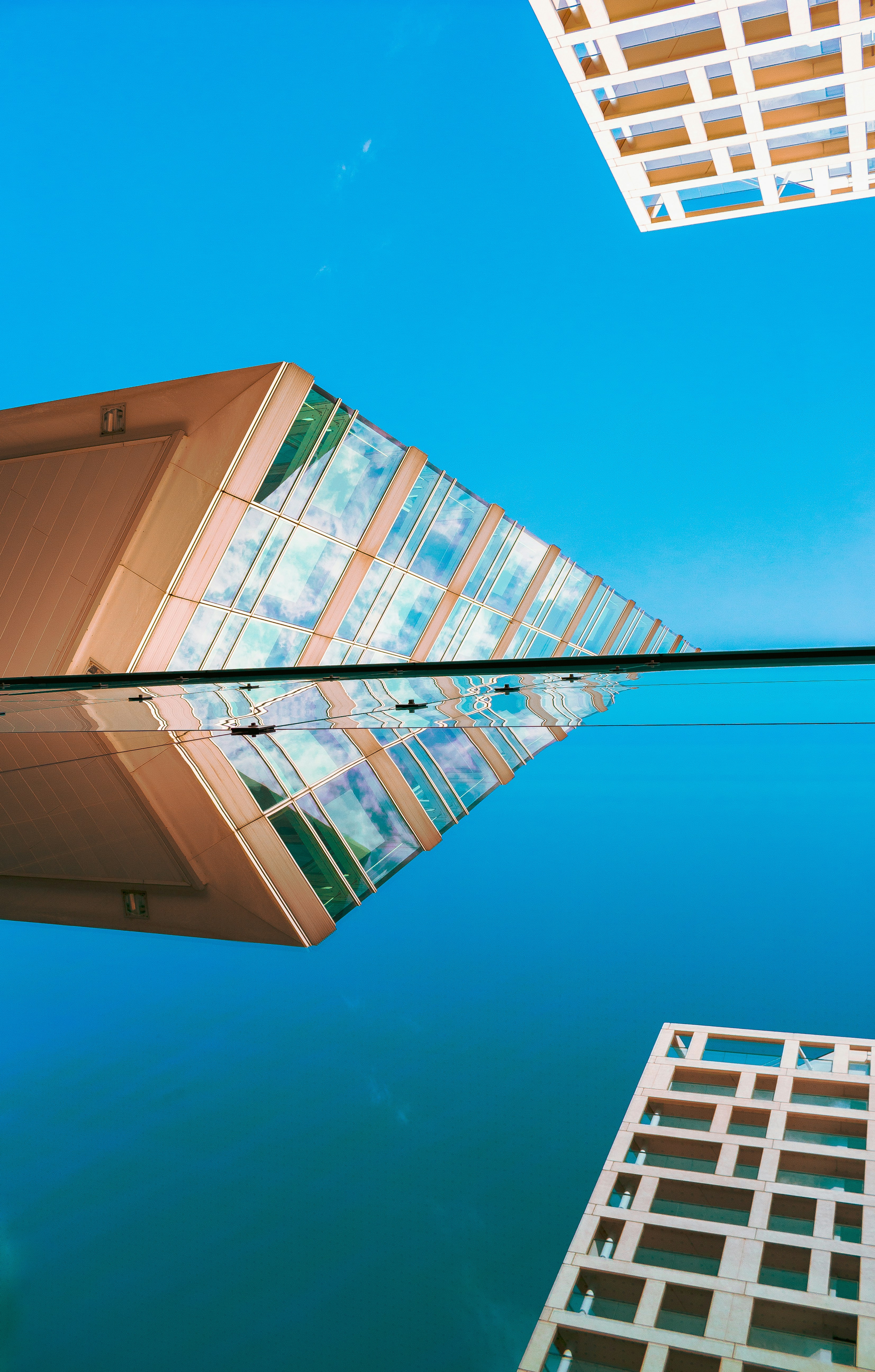reflection of building on glass window during daytime