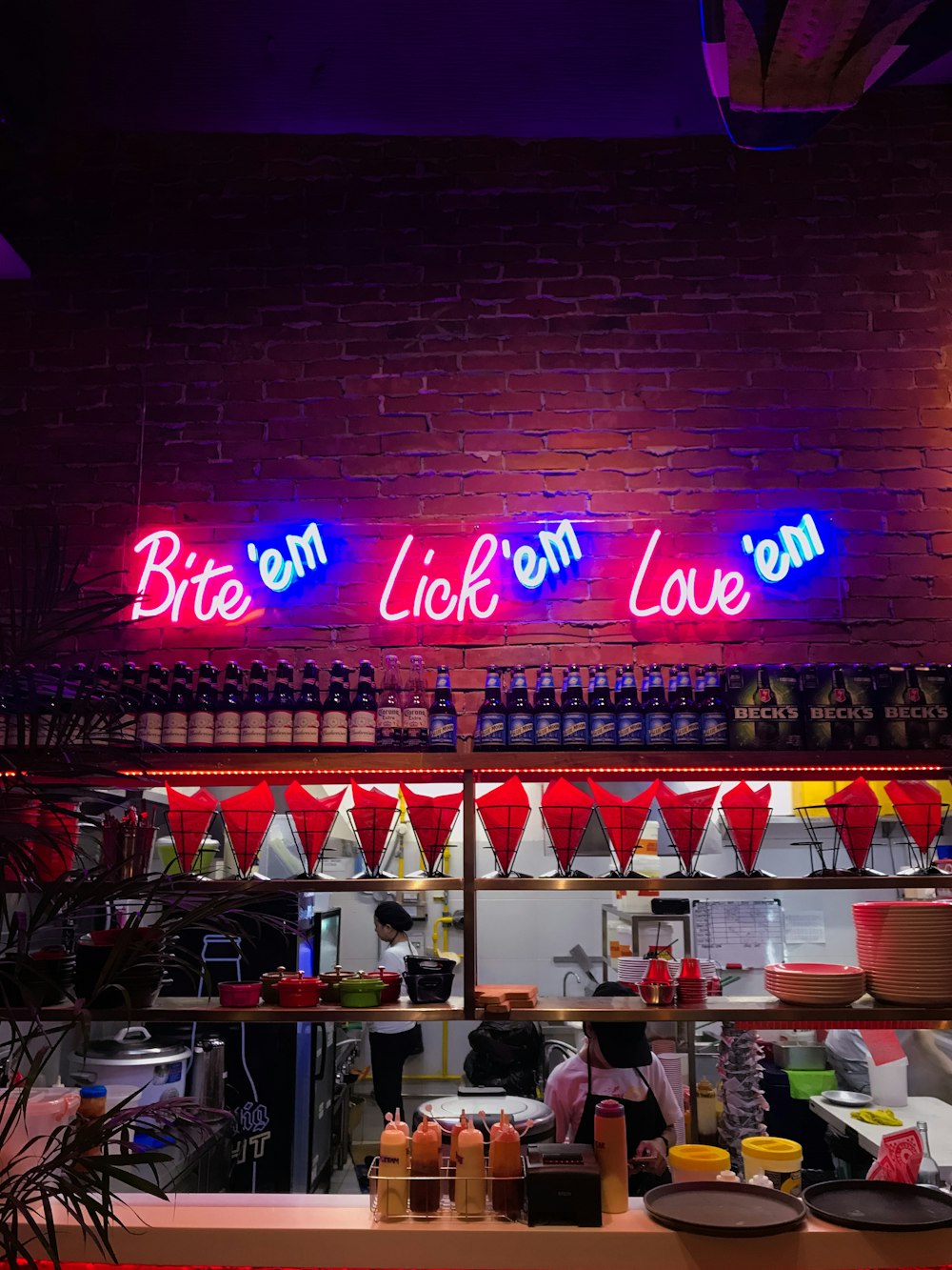 person taking photo of neon signage