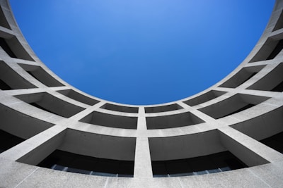 low angle photography of gray concrete building at day time