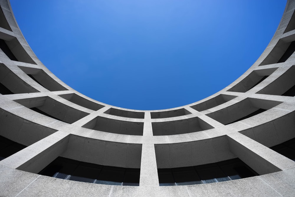 low angle photography of gray concrete building at day time