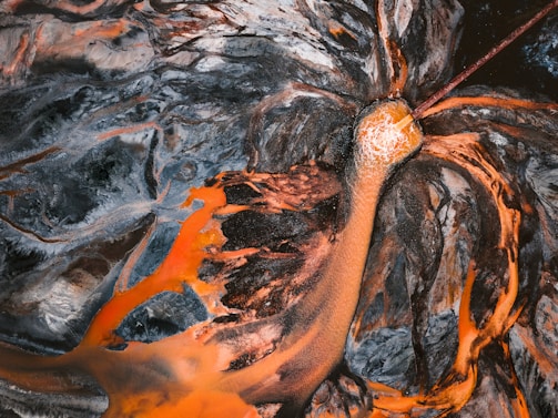 Aerial view of a vibrant abstract landscape with dark blue tones.