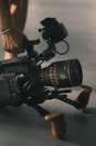 person holding video camera with stablizer