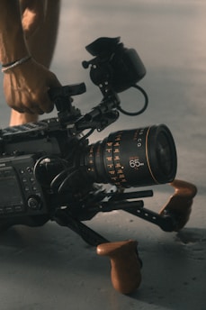 person holding video camera with stablizer