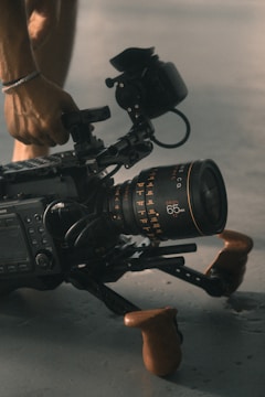 person holding video camera with stablizer