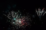 Close-up of colorful fireworks bursting against a dark evening backdrop.