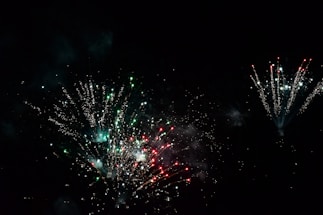 Close-up of colorful fireworks exploding in the night sky.