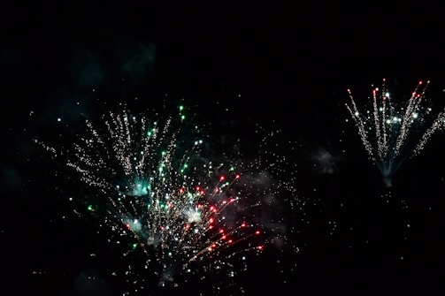 Close-up of colorful fireworks exploding in the night sky.