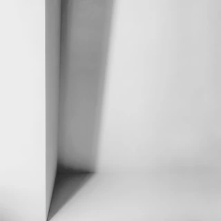 A minimalist paper design piece with subtle shadows creating depth.