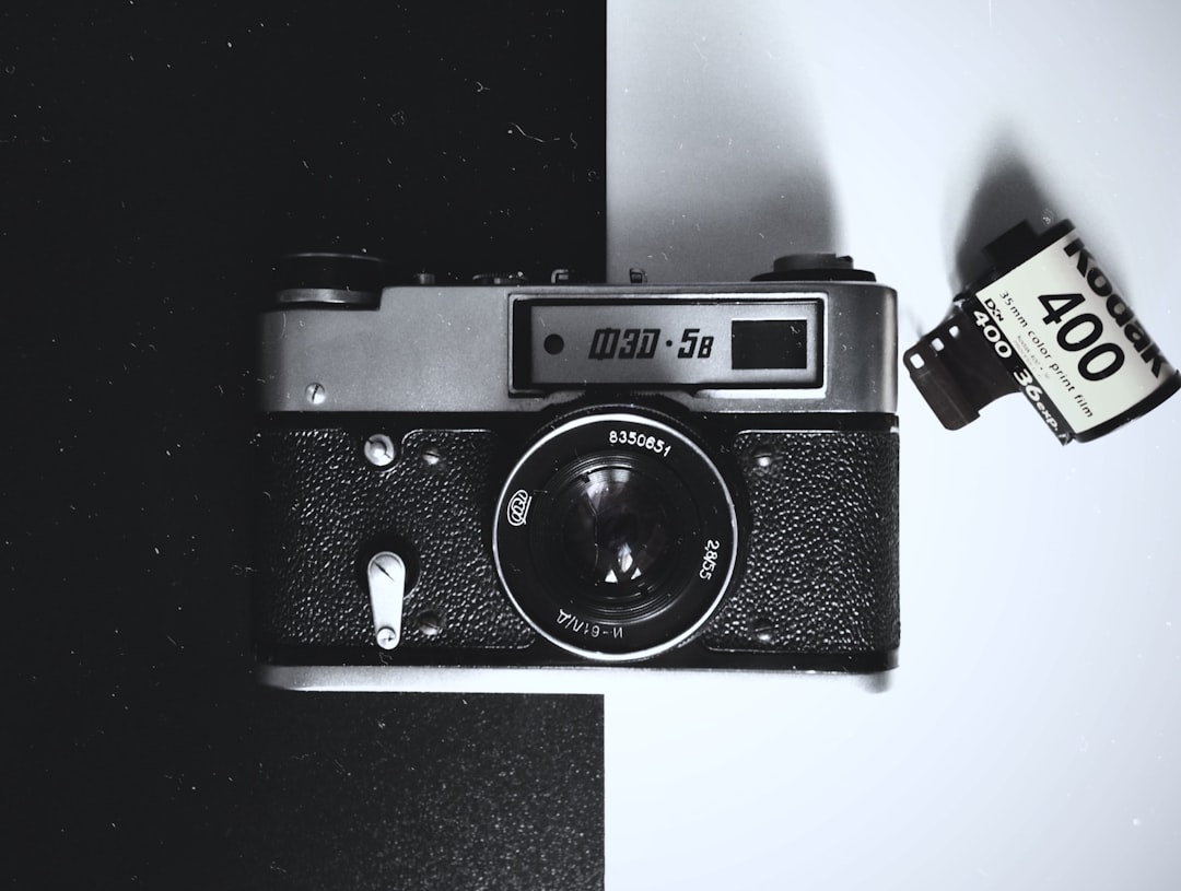 black and gray film camera on white and black board, This camera was a surprise for me, I found it from my parents, and did not understand how it works. It’s such a vintage and something completely new to me. Now I’m beginning to understand how it works and I have many plans, the film always gets more mysterious and lively footage.