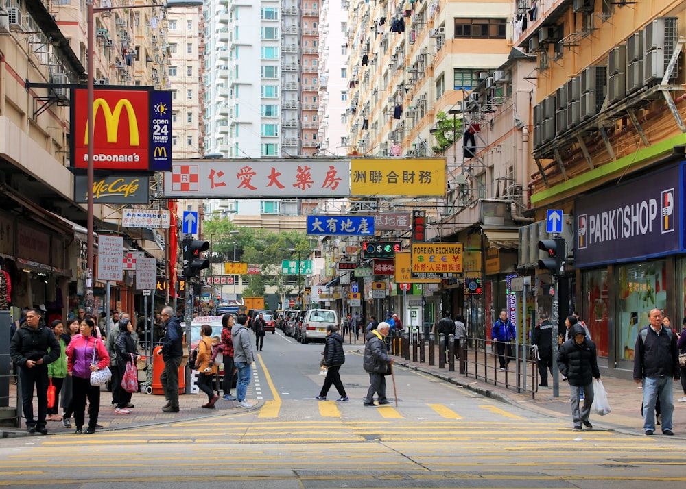 people walking on the road near buildings