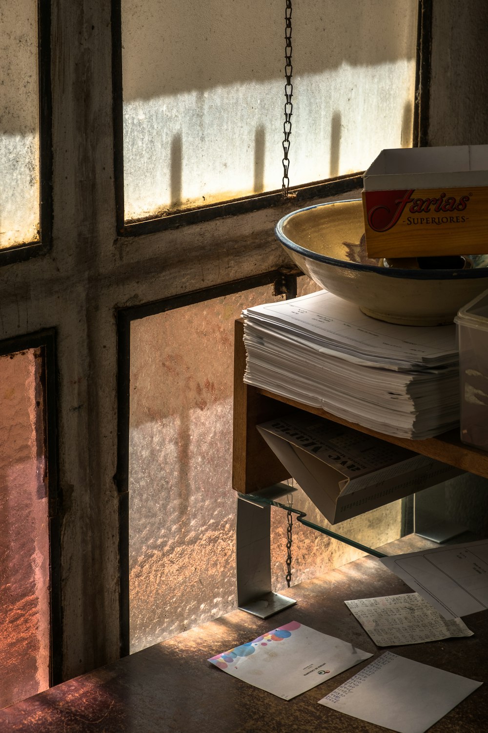 pile of papers near glass window