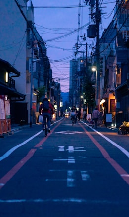 people riding bicycle on road