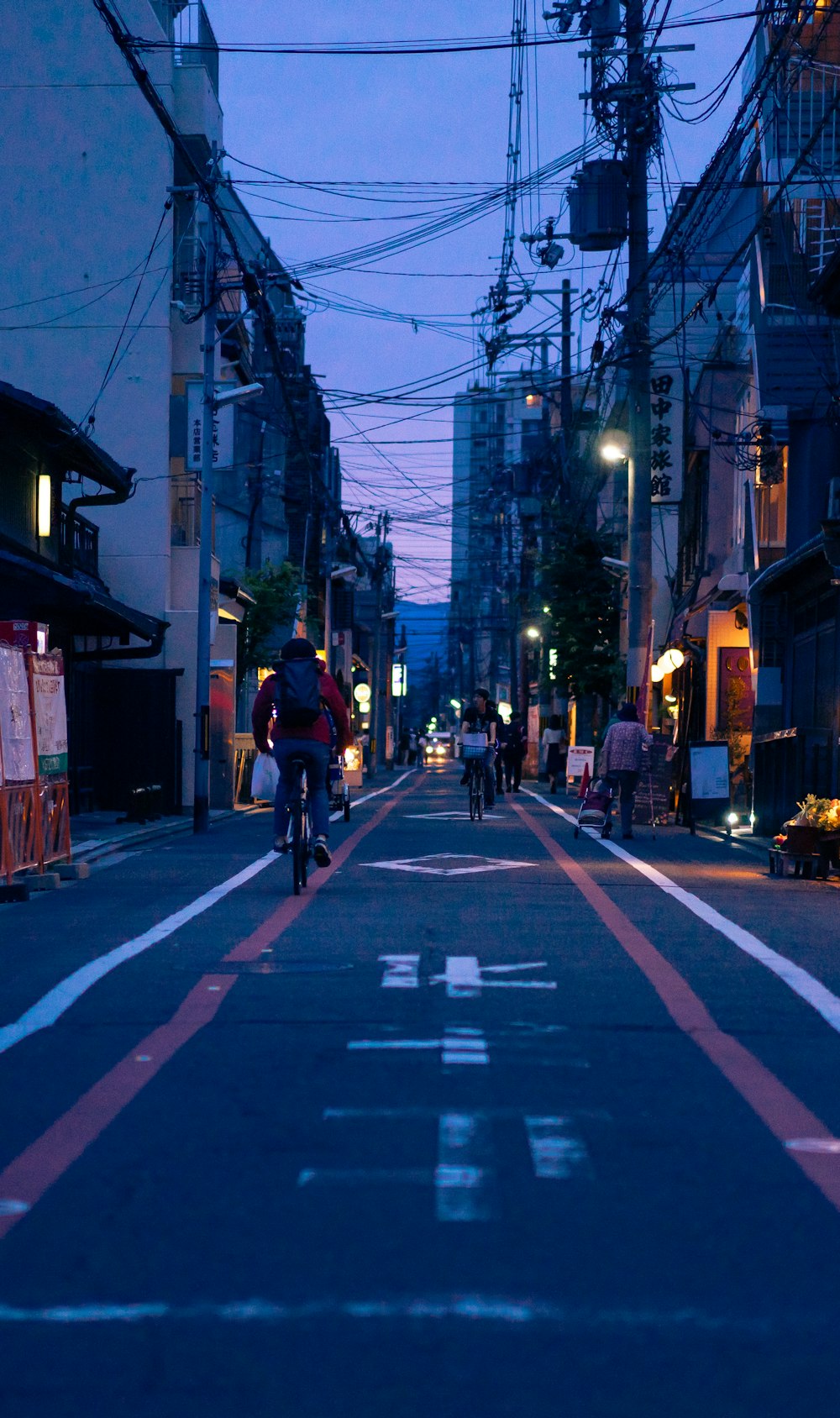 people riding bicycle on road