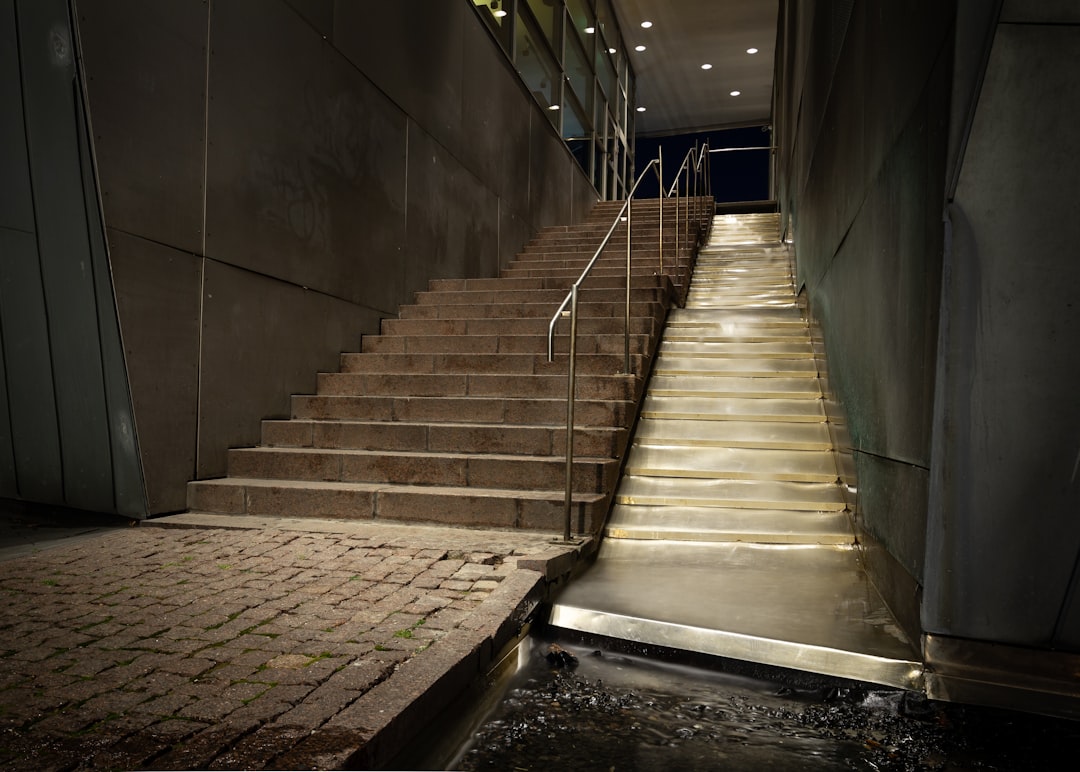 gray concrete staircase with stainless steel railings