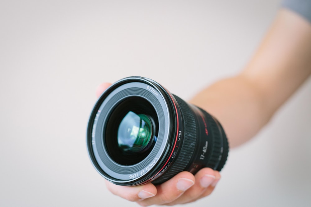 person holding black macro lens