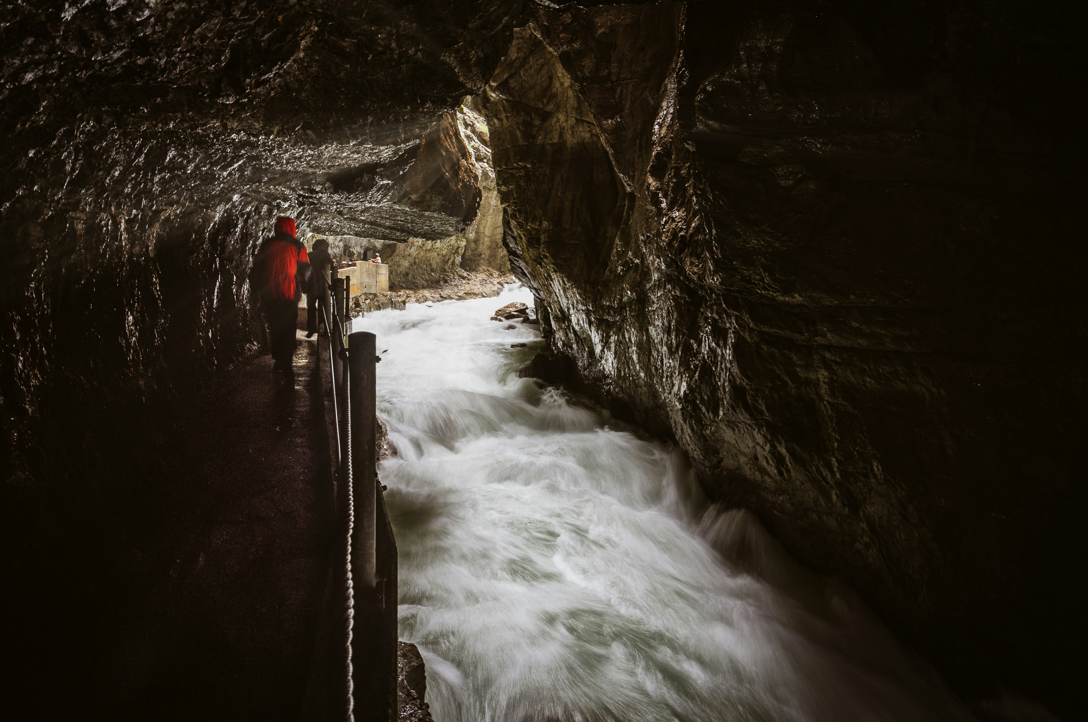 person standing on cave with eiver, Partnachklamm