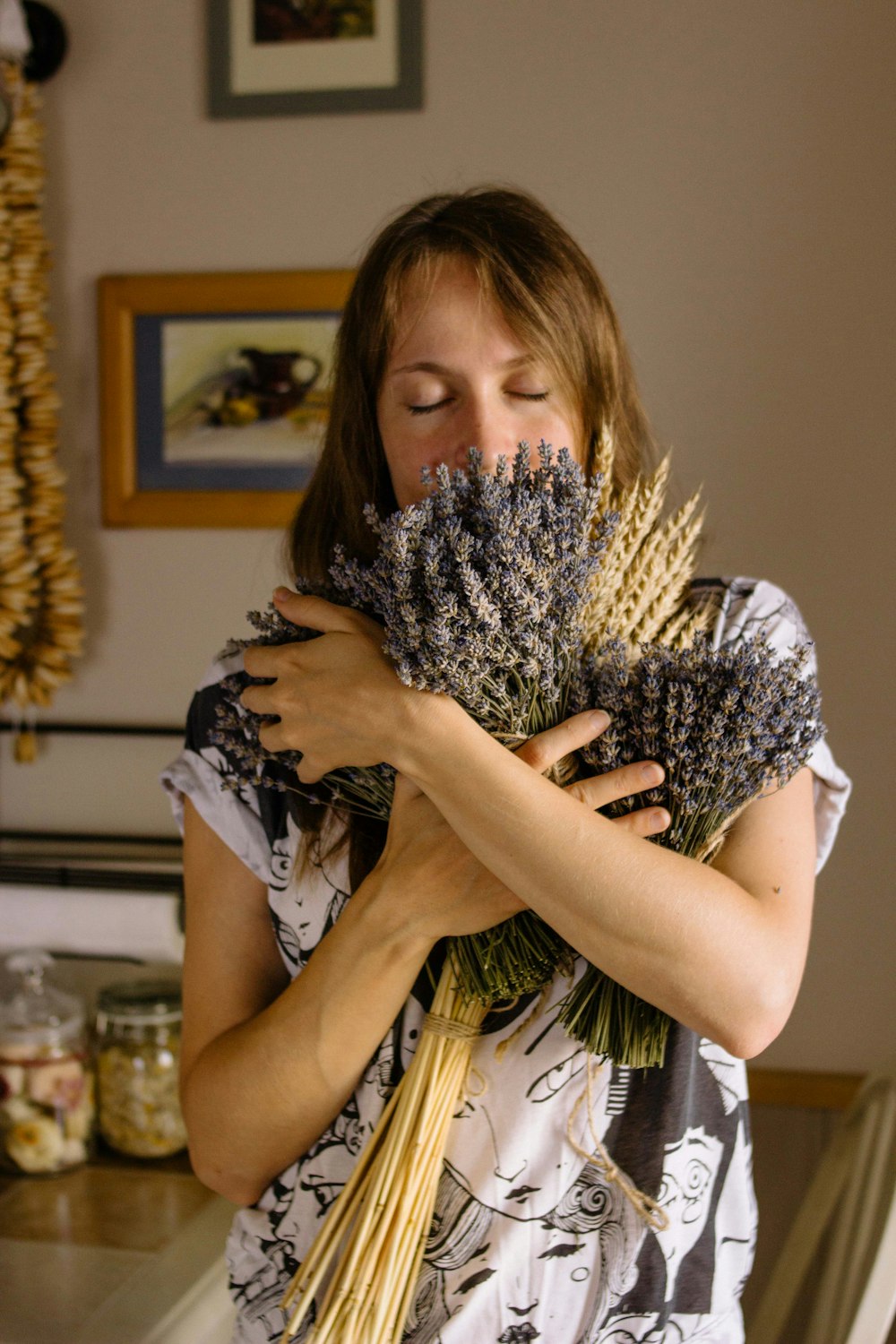 woman carrying bouquet of lavender flowers